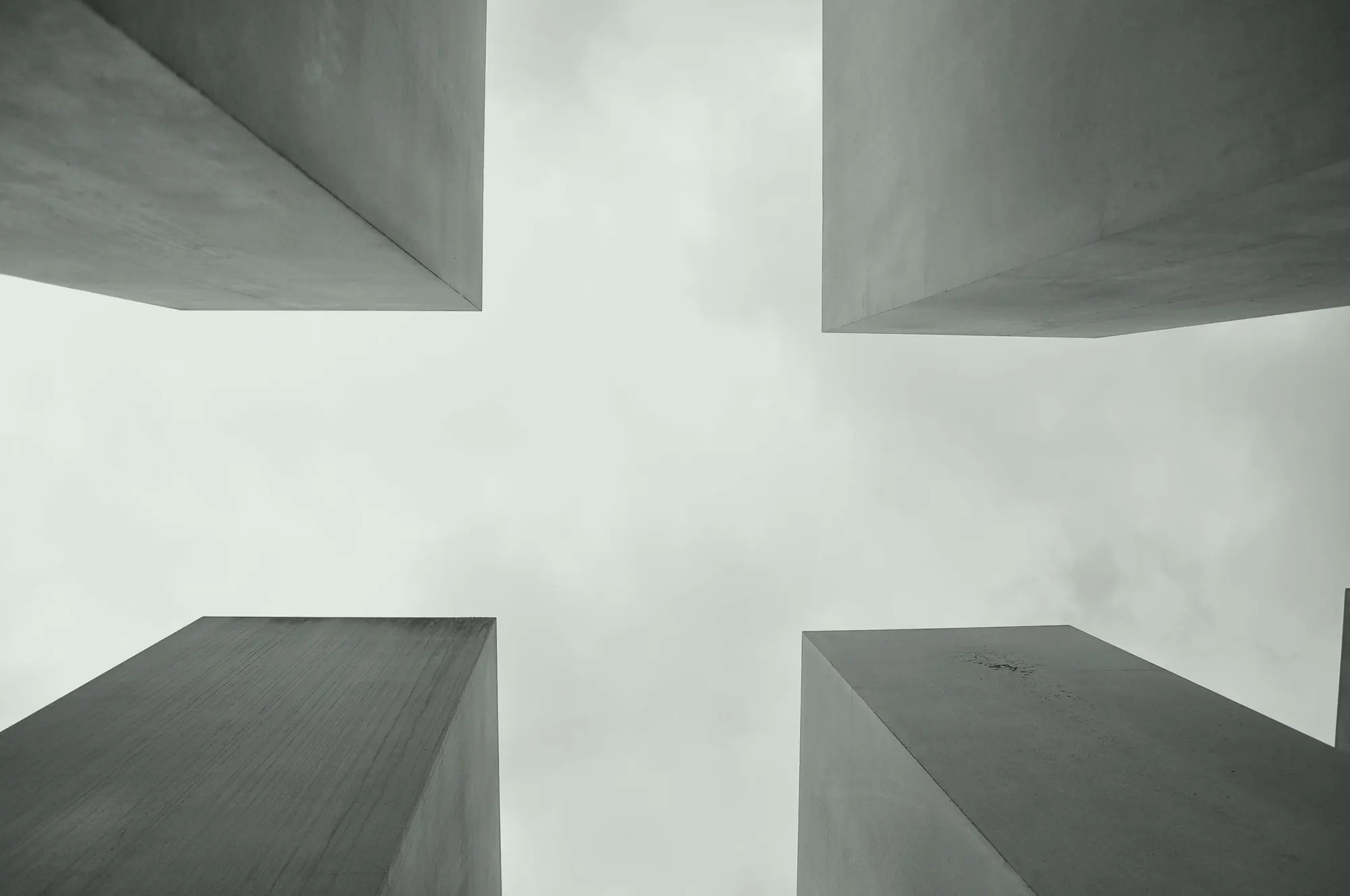 Four tower corners framing a cross of open sky